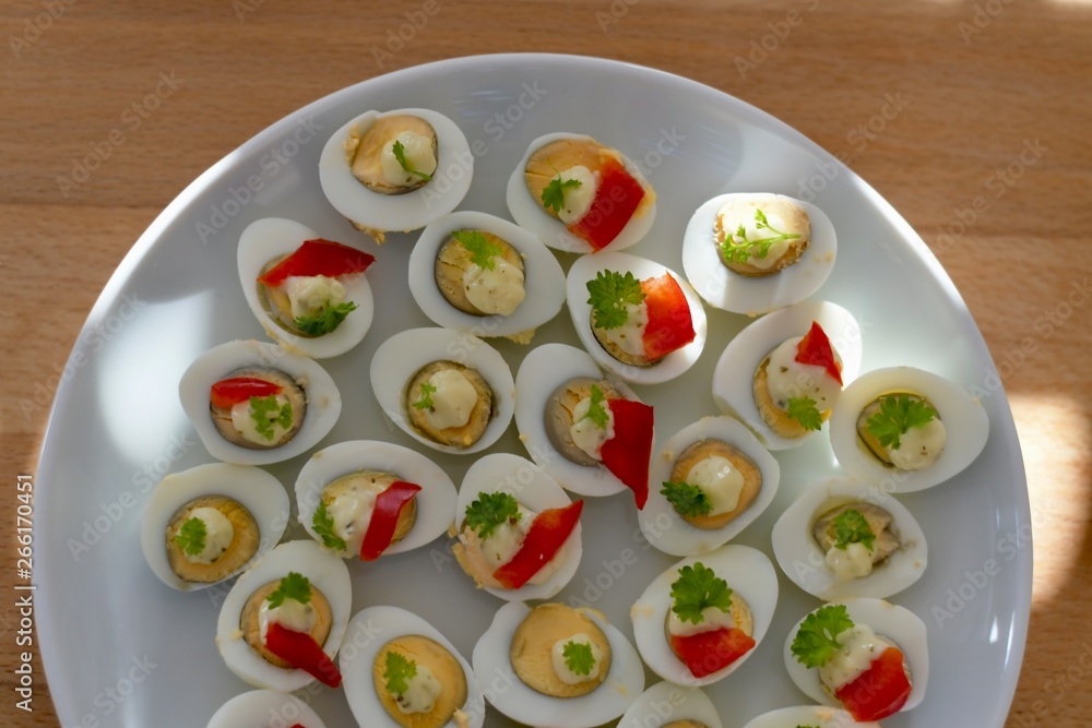 delicious plate of cooked quail eggs spiced with parsley and red paprika delicious plate of cooked quail eggs spiced with parsley and red paprika
