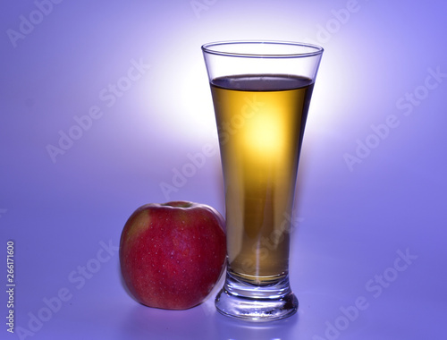 still life with an apple and a glass of apple juice