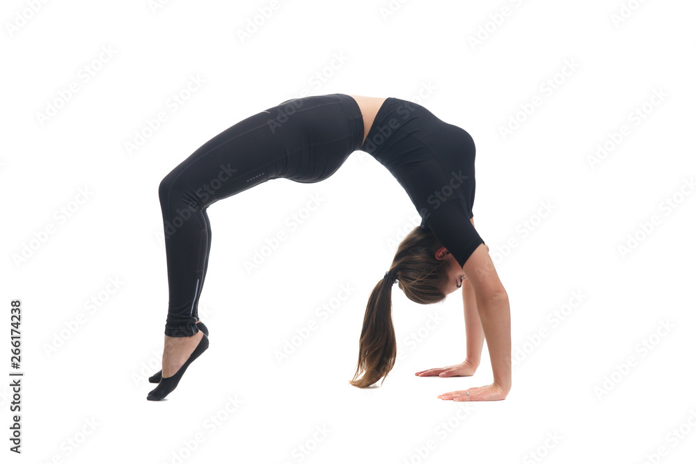 Slender girl is engaged in acrobatics isolated on white background.