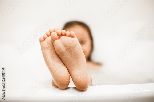 feet of a little girl bathing in a bath photo