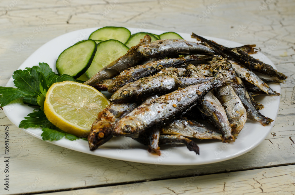 Pan-fried spiced sprats with a cucumber salad