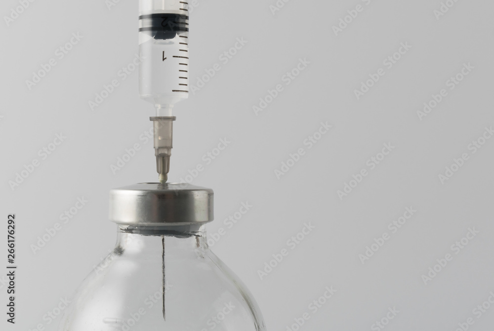 medical drugs and beauty products in glass jars for injections with a syringe with a needle on a white background medical drugs and beauty products in glass jars for injections with a syringe with a needle on a white background
