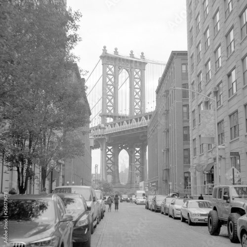 Photography Empire State Building framed by the Legs of the Manhattan bridge in New York City