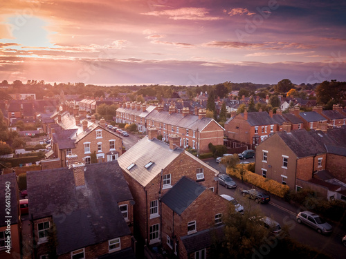 Photography Sun setting with atmospheric effect over traditional British houses and tree lined streets
