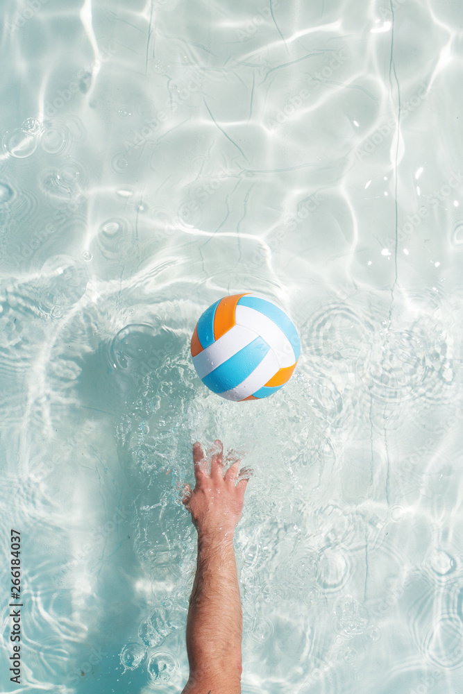 water polo player with a ball in a blue pool water. Top view. Copy space.