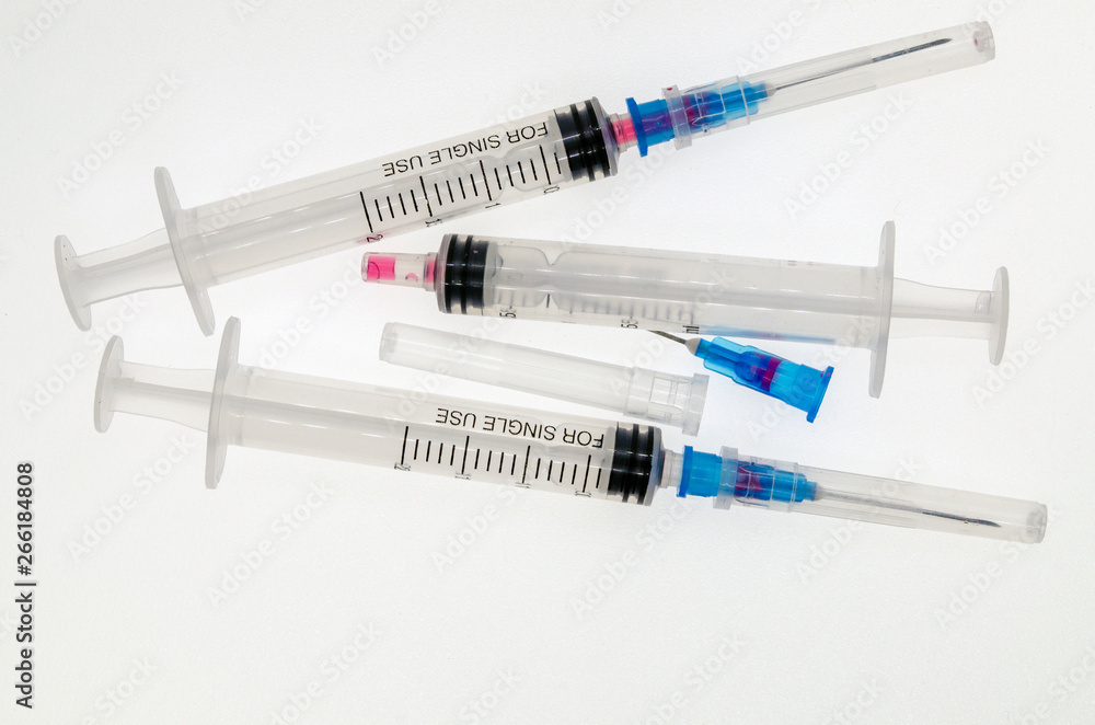 three disposable medical syringes on white background three disposable medical syringes on white background