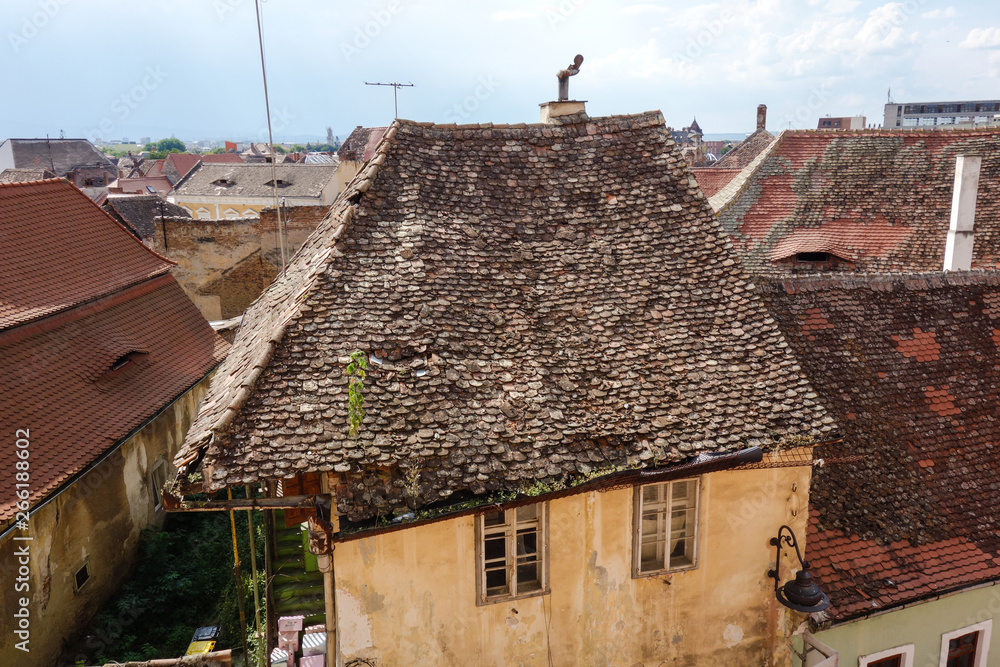 Weathered rooftop of an old house with an unique chimney in Sibiu (Hermannstadt), Romania Weathered rooftop of an old house with an unique chimney in Sibiu (Hermannstadt), Romania