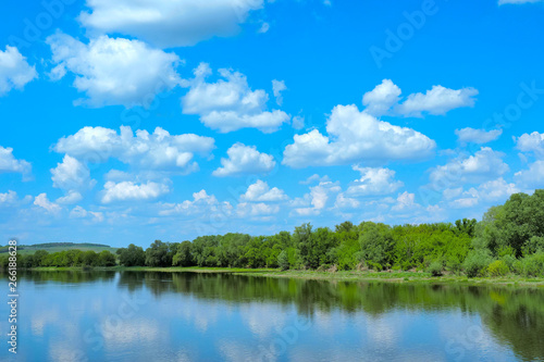 river with a green bank and clouds © Александр Володьков