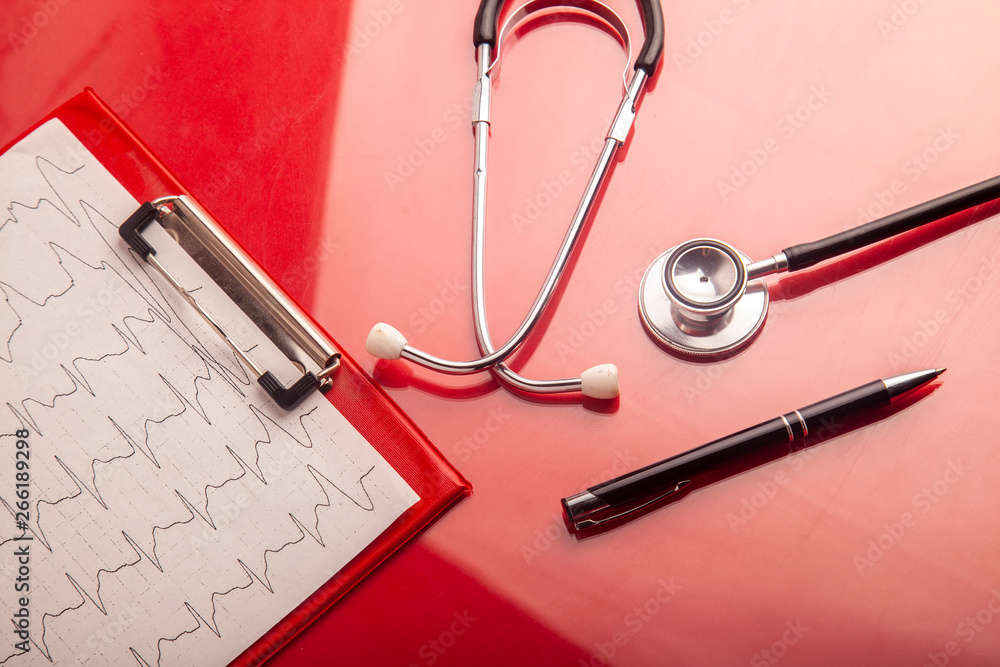 Medical concept. Stethoscope and heart rate cardiogram diagnostic on red background. Medical concept. Stethoscope and heart rate cardiogram diagnostic on red background.