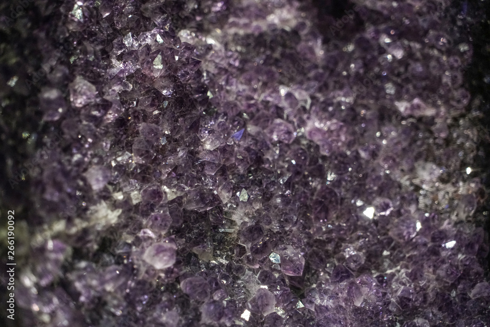 Obraz premium Amethyst cluster rough crystals close up in low light background