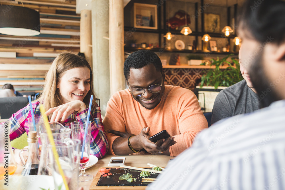 Meet young attractive people in the cafe. Friends chat, have fun, drink cocktails and eat Meet young attractive people in the cafe. Friends chat, have fun, drink cocktails and eat