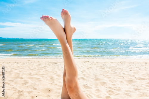 Beautiful woman legs on the beach