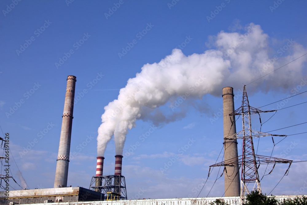White polluting chimney smoke with blue sky. White polluting chimney smoke with blue sky.