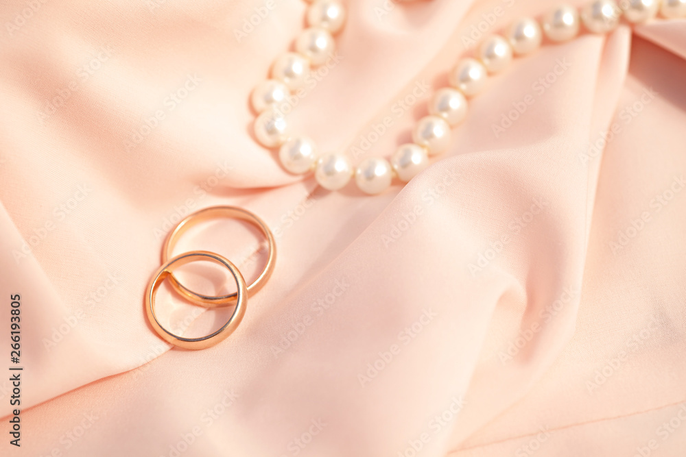Wedding rings on a pink silk background Wedding rings on a pink silk background