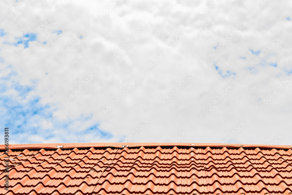 Red roof with a cloudy blue sky on top Red roof with a cloudy blue sky on top
