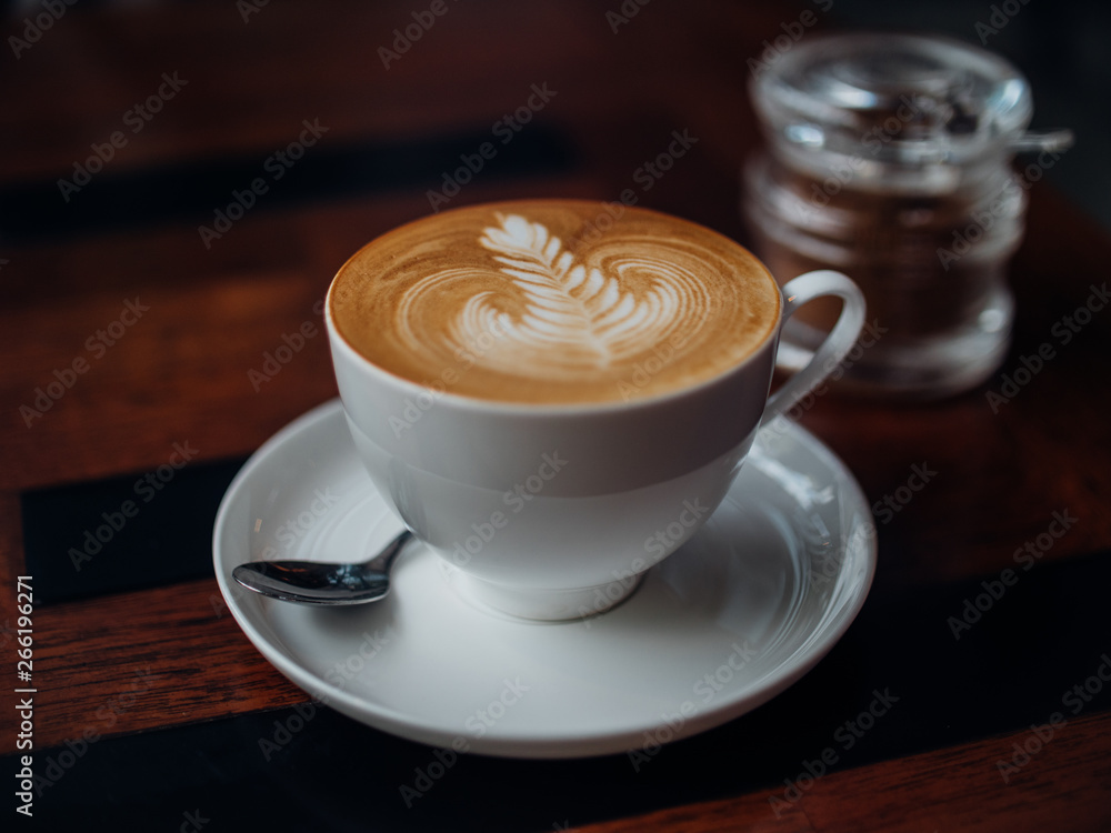 coffee latte art in cafe with woman hand coffee latte art in cafe with woman hand