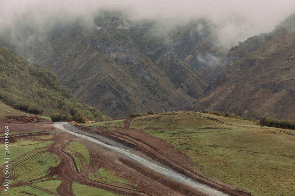 Road in the Caucasus Mountains in foggy day