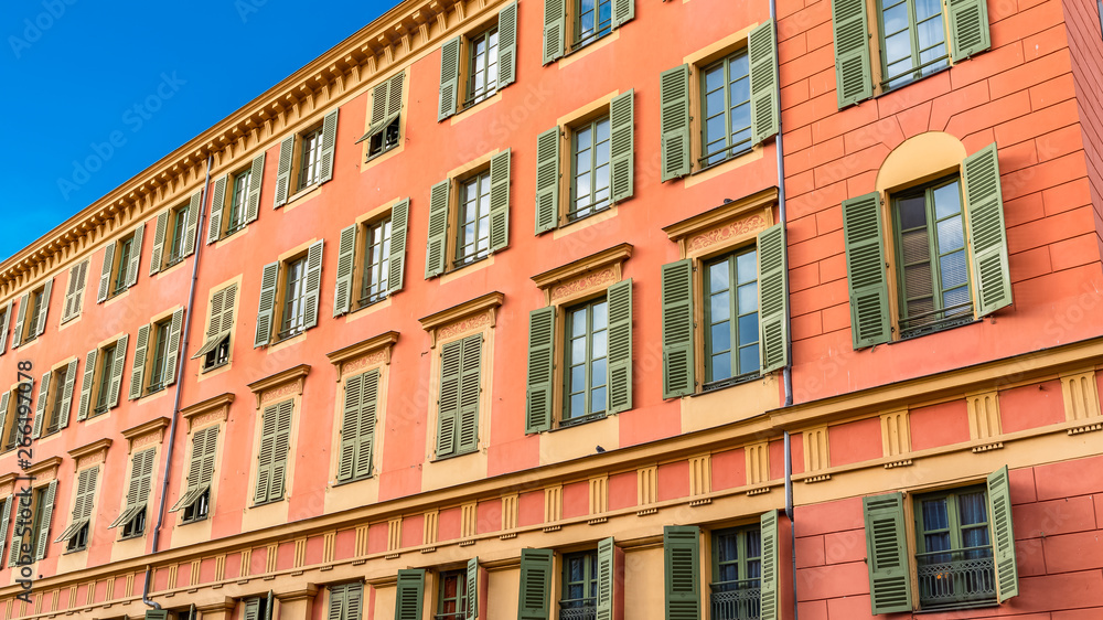 Nice, France, colorful facade, with typical windows and shutters 