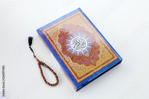 Ramadan kereem with holy quran, dates and rosary isolated on white background