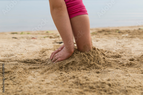 the child play with sand at the beach by the sea in the summer for holiday concept.