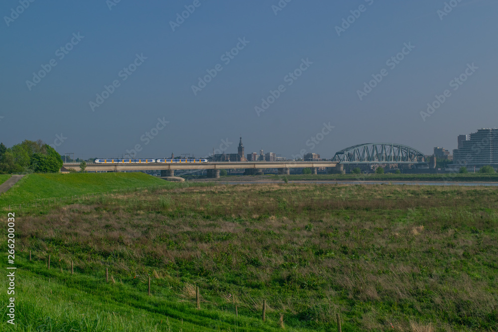 Dutch passenger train passing a bridge