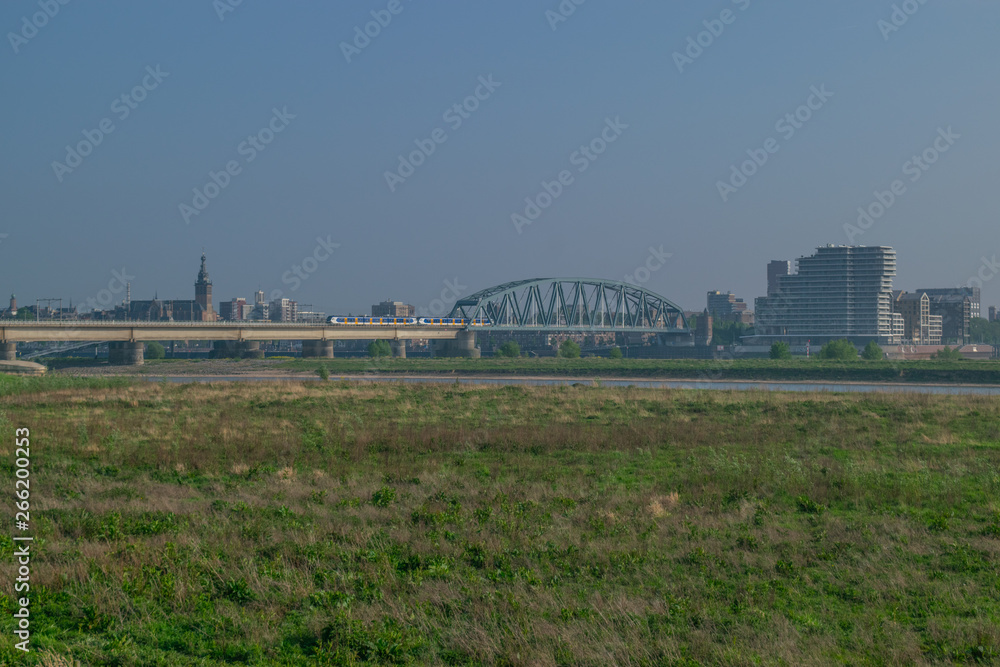 Dutch passenger train passing a bridge