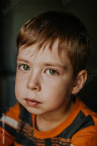 portrait of a boy with big green eyes