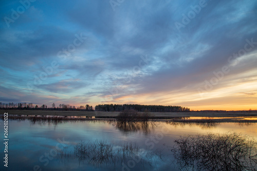 Beautiful spring landscape with clouds at sunset.