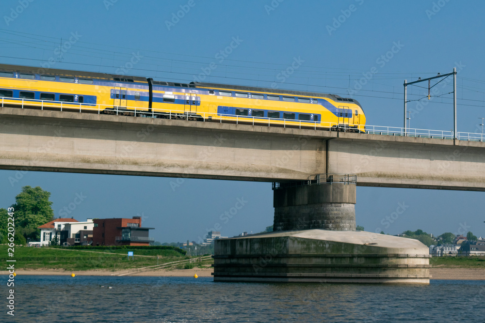 Dutch passenger train passing a bridge Dutch passenger train passing a bridge