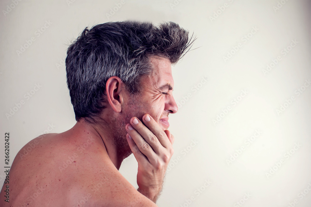 Man feels strong tooth pain. People, healthcare and medicine concept Man feels strong tooth pain. People, healthcare and medicine concept