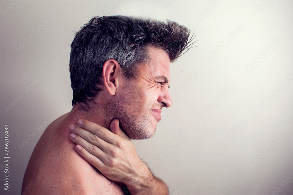 Obraz premium Man feels strong neck pain. People, healthcare and medicine concept