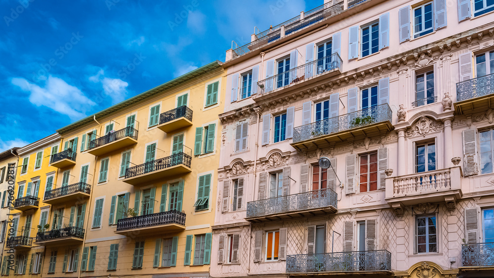 Nice, France, colorful facade, with typical windows and shutters 