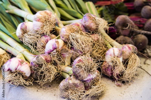 Fresh harvested garlic and beetroot for sale at farmers market in France in summer.