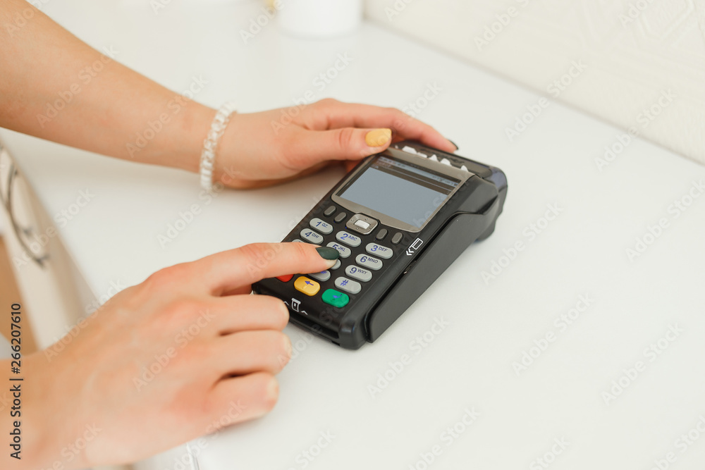 Woman pay with credit card in beautician clinic background. Woman pay with credit card in beautician clinic background.