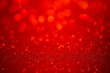Red glitter christmas abstract background. Defocused sequin light.