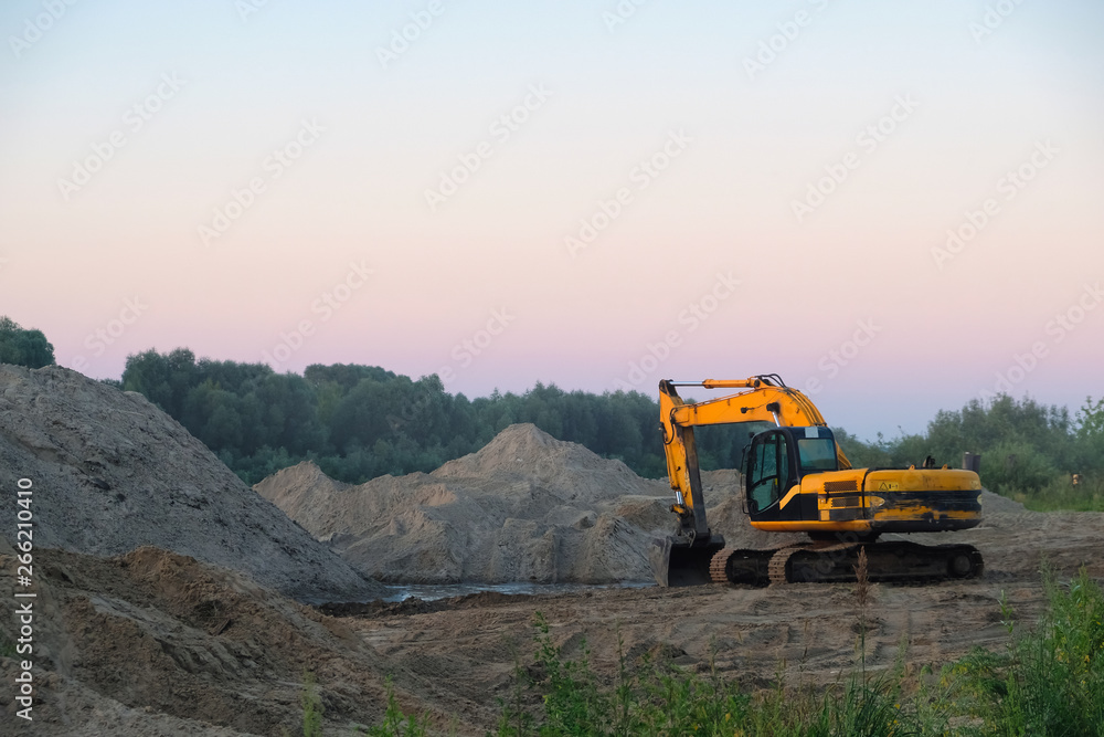 excavator is standing on the sand