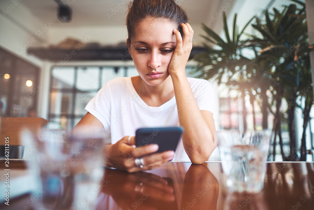 Portrait of beautiful girl using her mobile phone in cafe. Portrait of beautiful girl using her mobile phone in cafe.