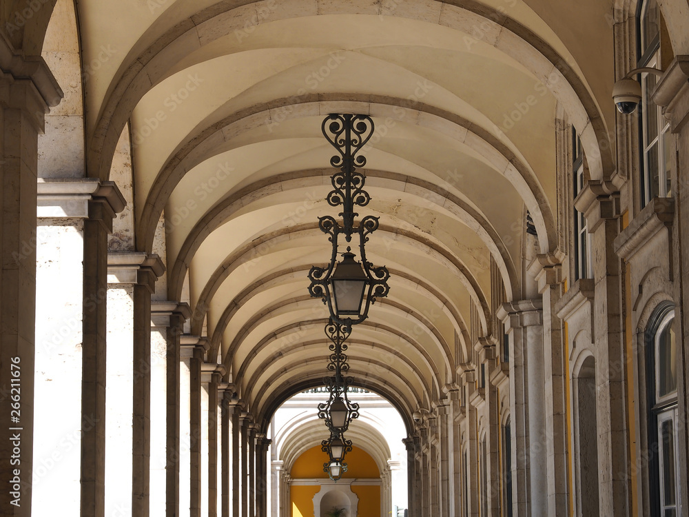 Beautiful arcades in Lisbon with traditional lamps
