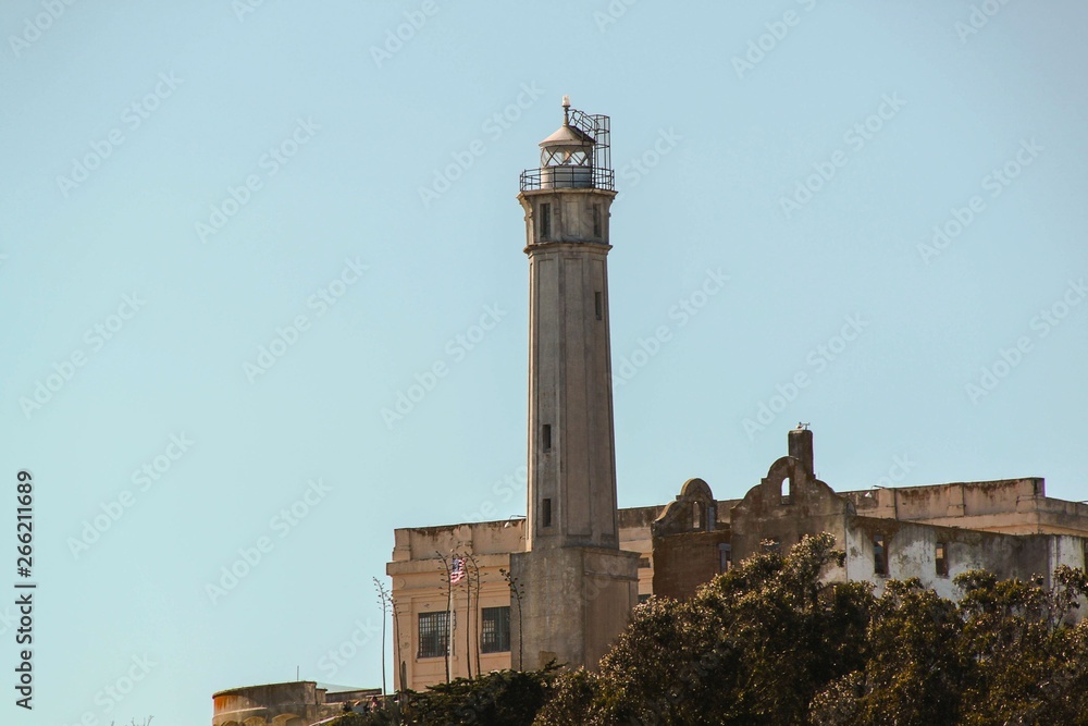 View on Prison Alcatraz. Lighthouse on blue sky background.  Alcatraz island background. San Francisco. USA. 