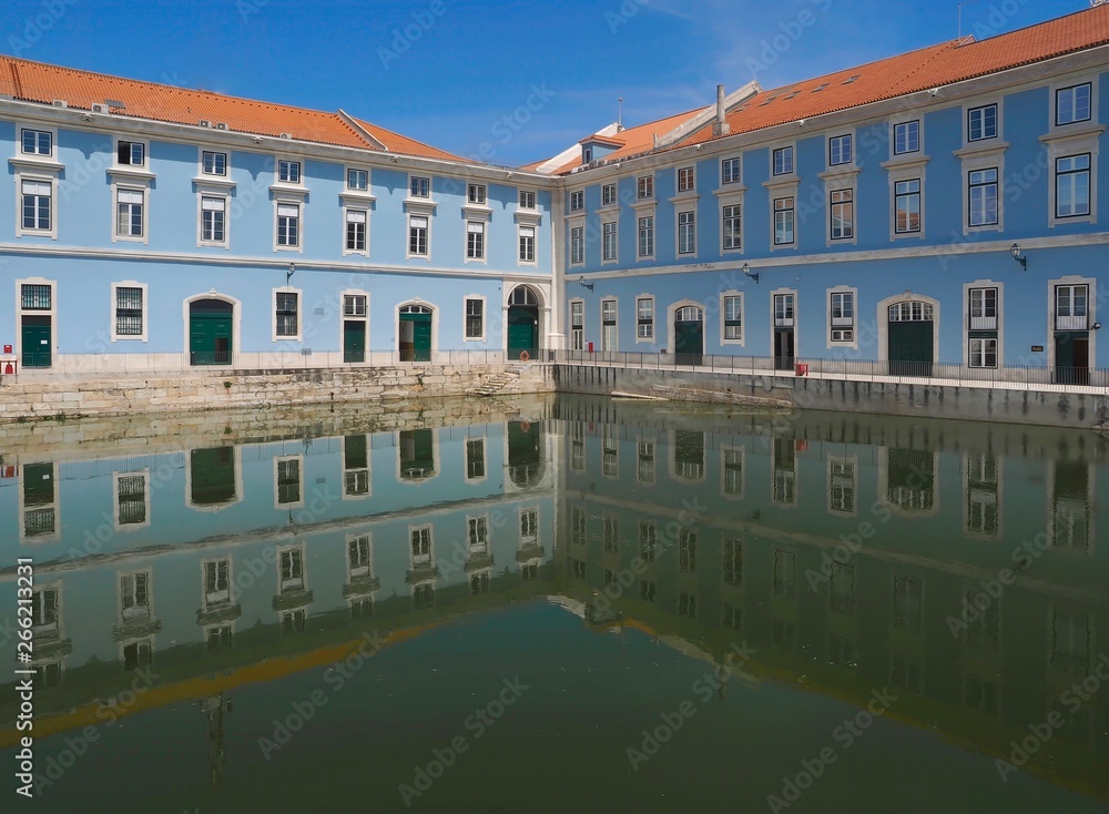 Blue marine administration building mirrors in water