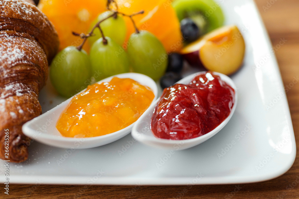Close up of breakfast plate - fresh fruit and jam Close up of breakfast plate - fresh fruit and jam