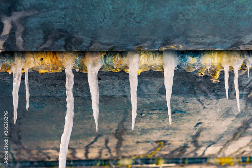 icicles hang from the drainpipe