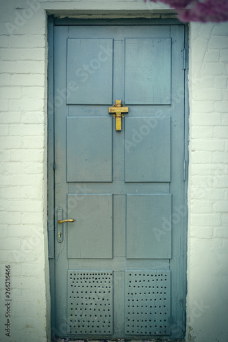 Wooden old door with a christian cross. The concept of religiosity, the path to God. © Konstiantyn Zapylaie