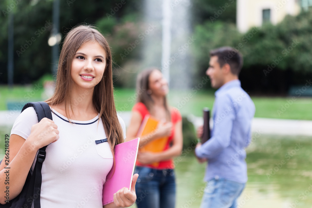Smiling young woman in front of a group of students Smiling young woman in front of a group of students