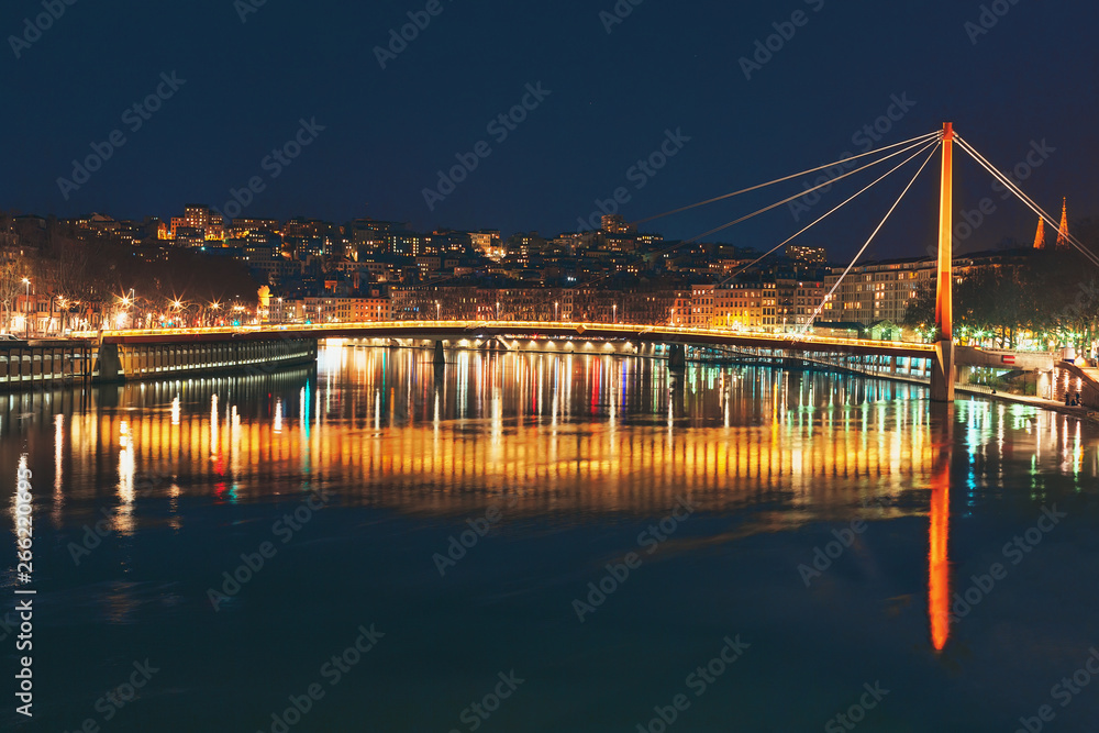 Night view on Passerelle du Palais de Justice and Saone river. Lyon, France