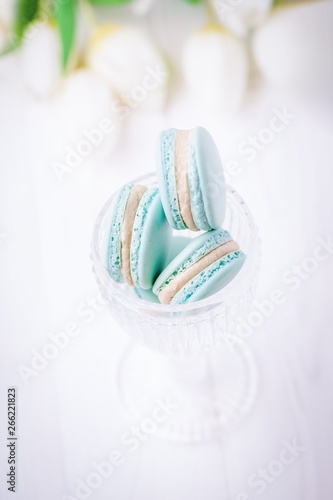 Mint or tiffany color macaron or macaroon dessert with vanilla cream on white background. Copy space