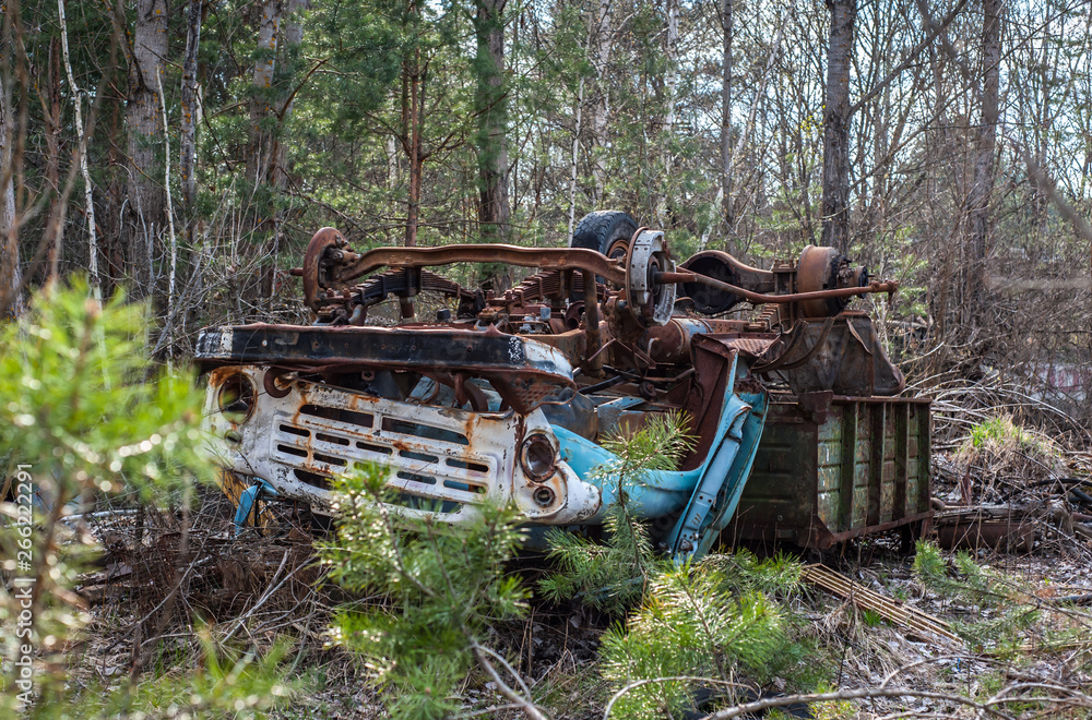 Broken and abandoned rusty track ZIL lays upside down in Chernobyl Exclusion Zone