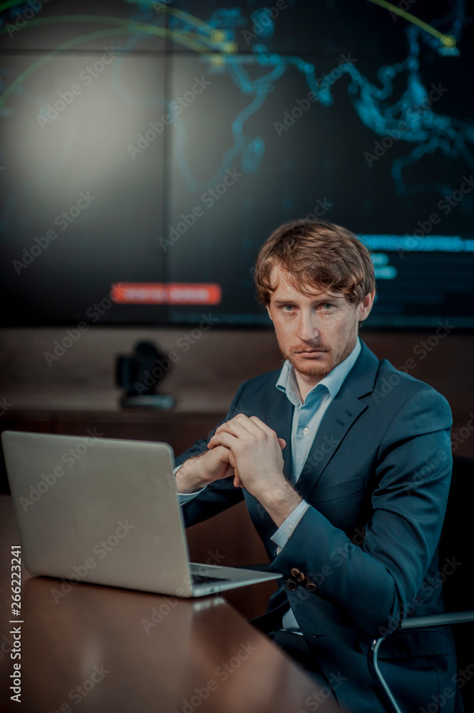 Young it engeneer business man with thin modern aluminium laptop in network server room Young it engeneer business man with thin modern aluminium laptop in network server room