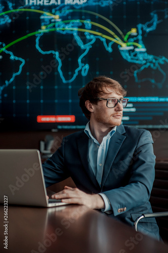  Young it engeneer business man with thin modern aluminium laptop in network server room