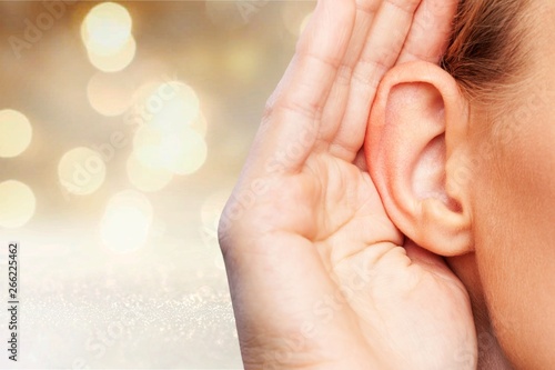 Foto Girl listening with her hand on an